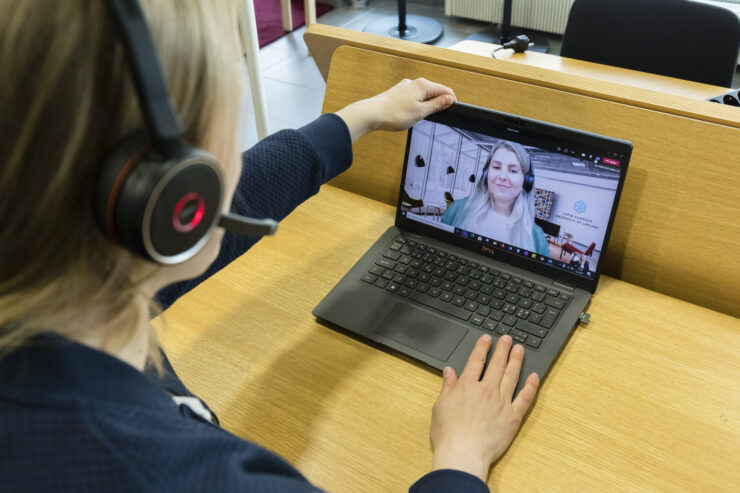 A person is on a video call on their laptop, talking with someone.